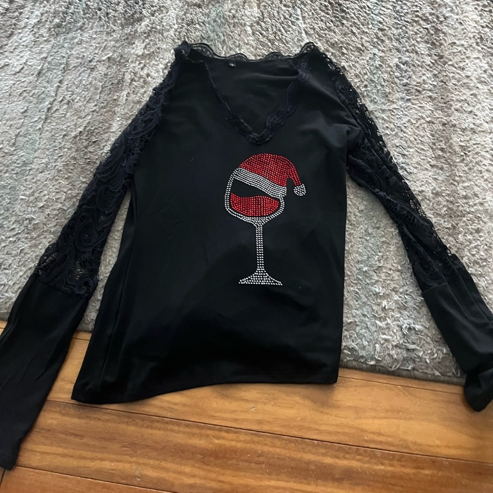 Size small. Never worn. See through arms wine with Santa hat in rhinestones